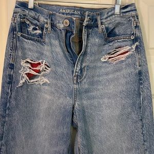 AE jeans with rips and flannel patches